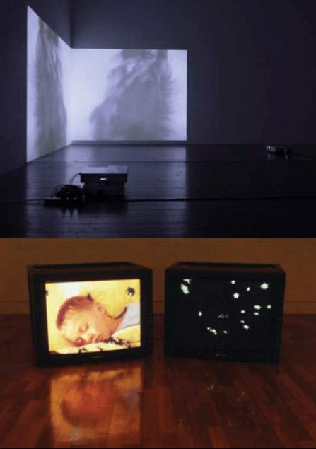 A video projection of a horse and a boy sleeping.