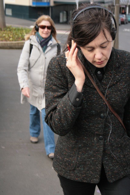 A woman listening to headphones.