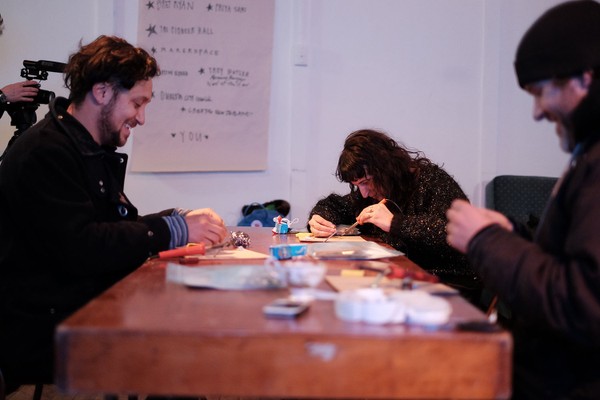 Three people at a desk.