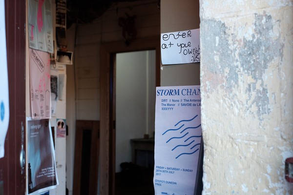 An entranceway with posters on the walls.