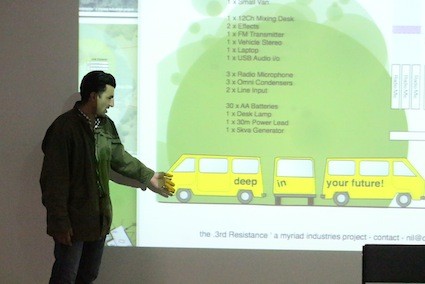 A man pointing to a Powerpoint presentation.