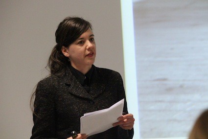 A closeup of a woman giving a presentation.