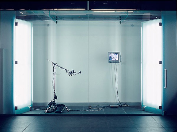 An empty room with a microphone and a screen.